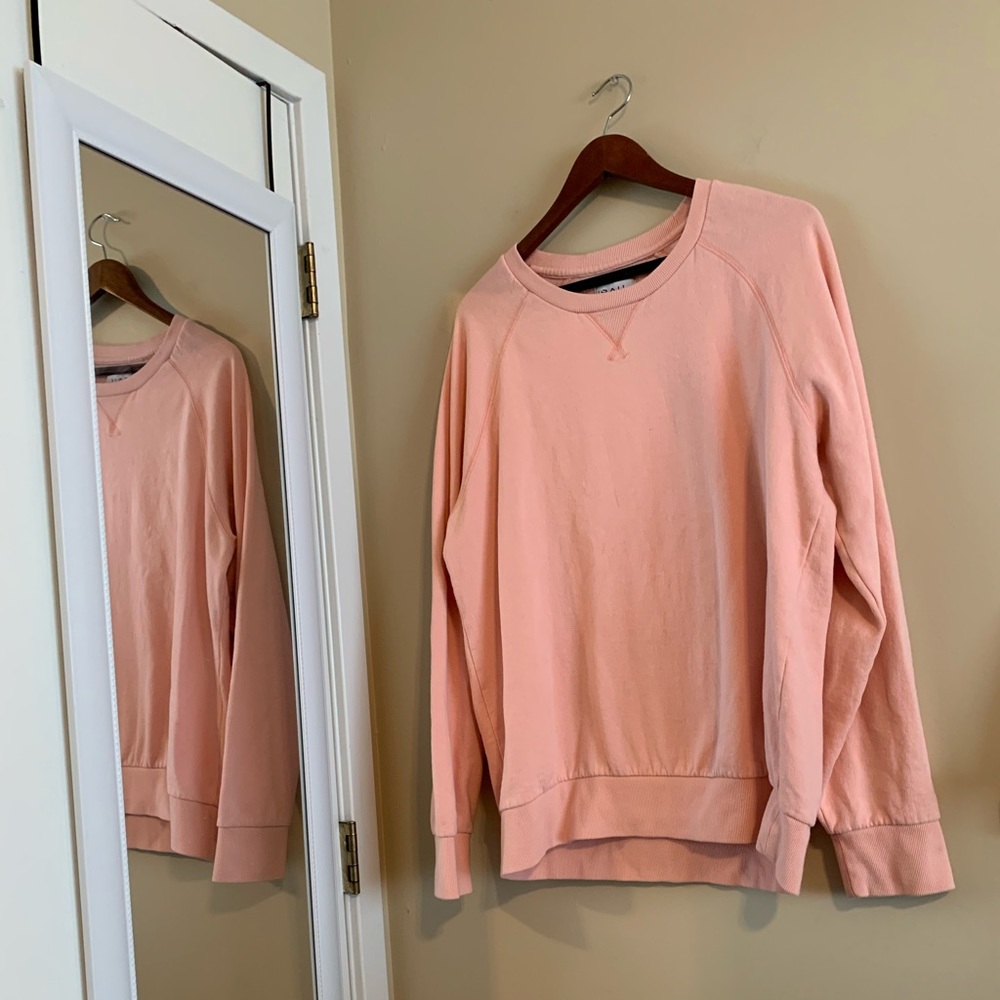 Adorable pink sweater.